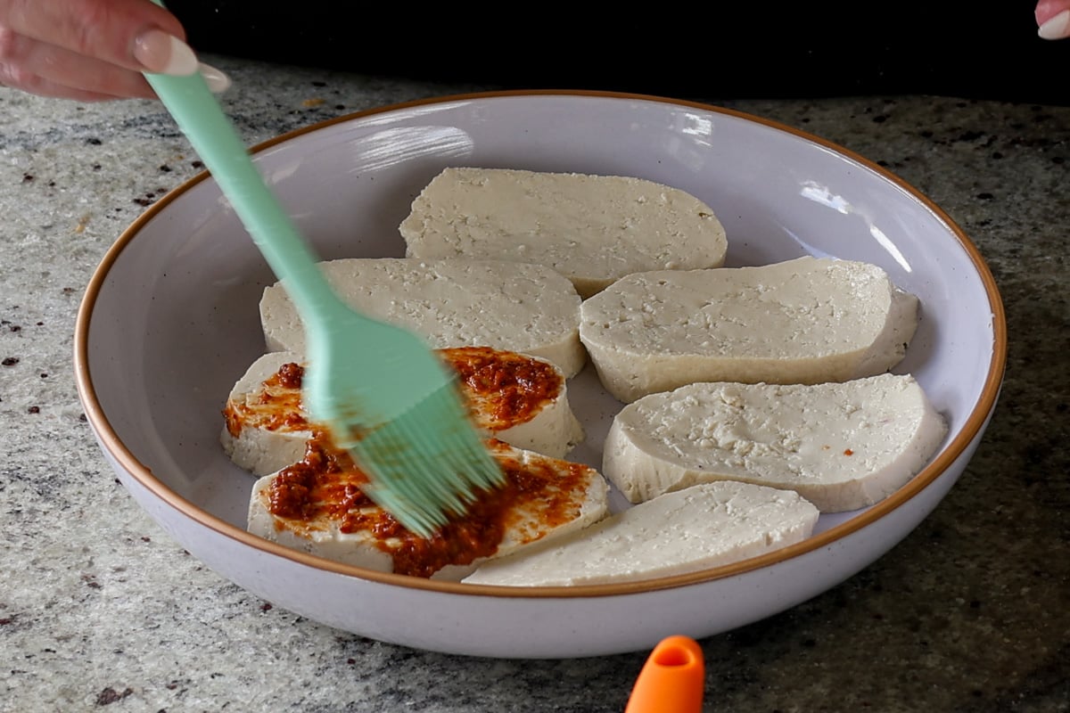 brushing the peri peri masala onto the tofu