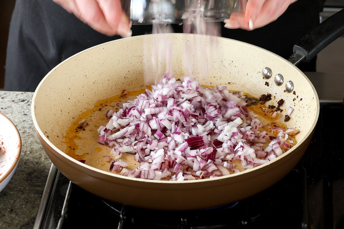 adding onion to the pan