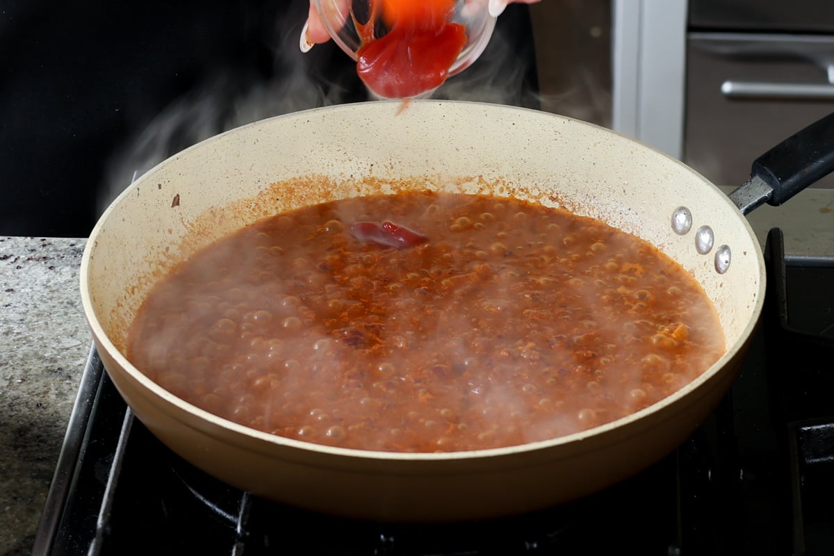 adding ketchup to the pan