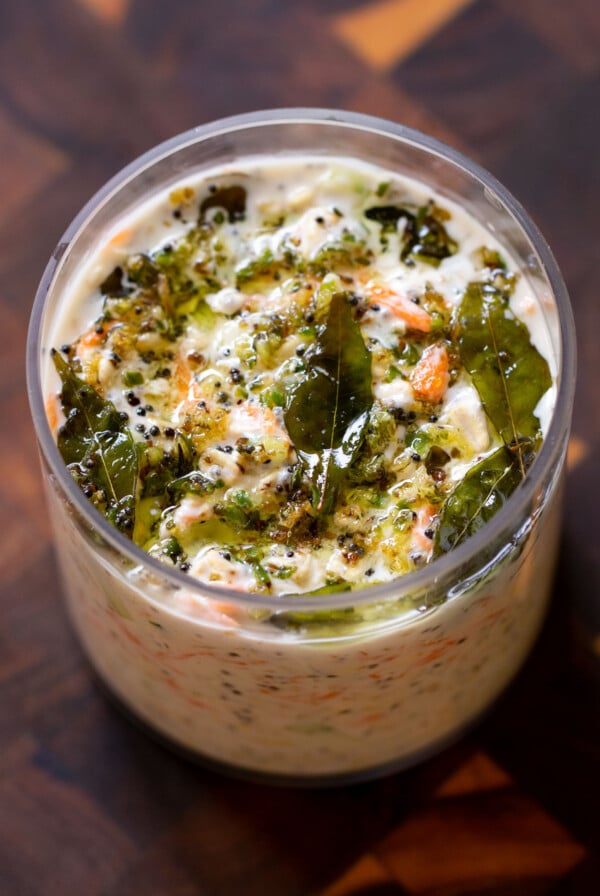 savory overnight oats topped with Indian spiced tempering in a glass jar