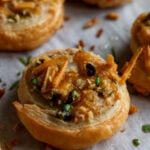 close-up of jalapeño popper pinwheel on the baking sheet after baking