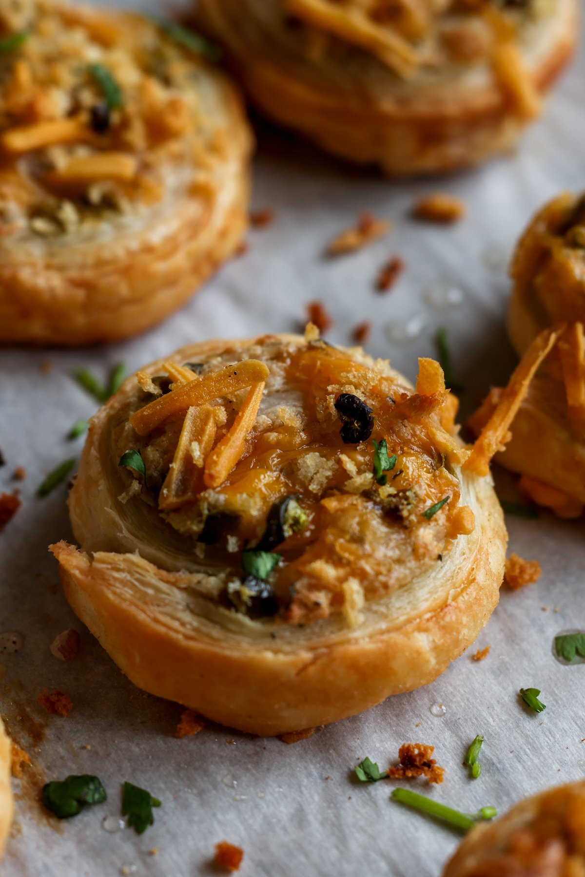 close-up of jalapeño popper pinwheel on the baking sheet after baking