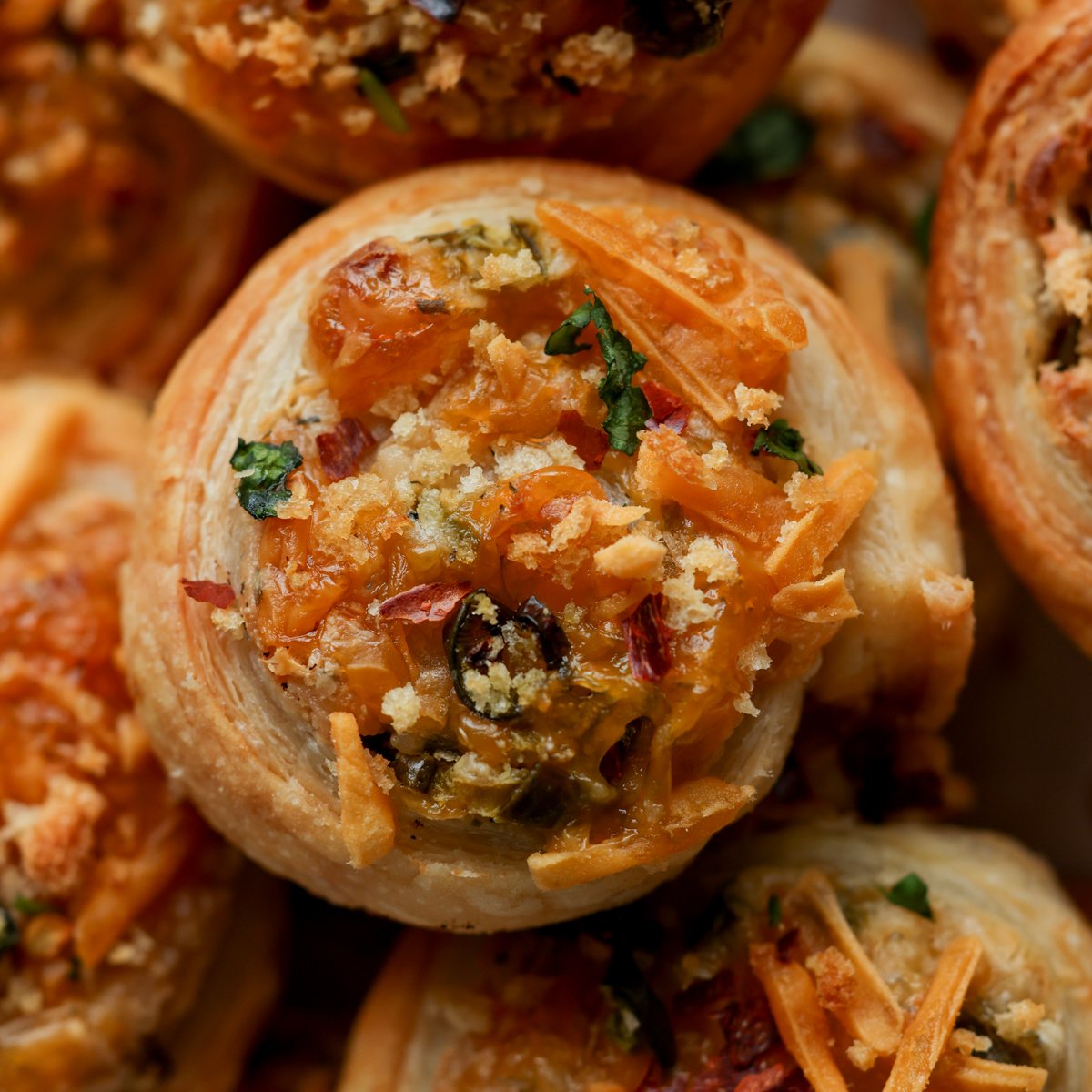 close-up of jalapeño popper pinwheels on the baking sheet after baking