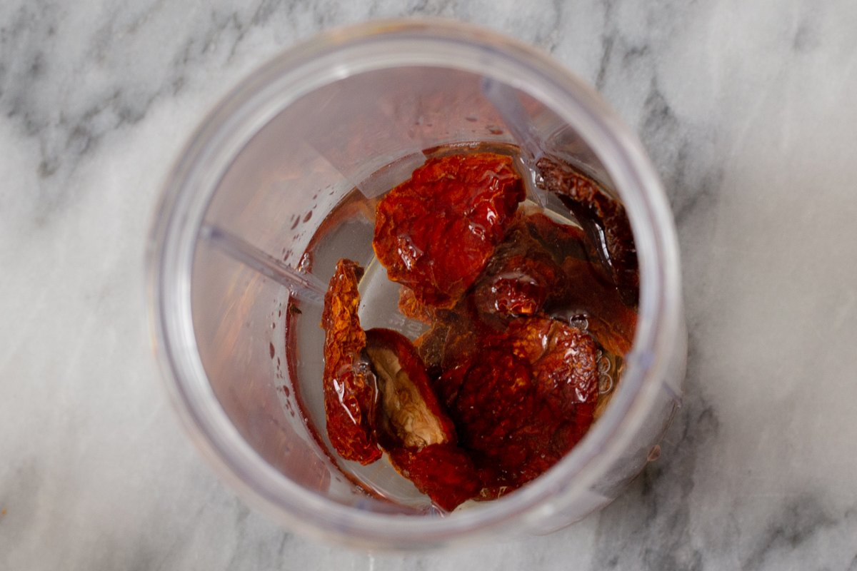 soaking sun-dried tomatoes in hot water in the blender canister