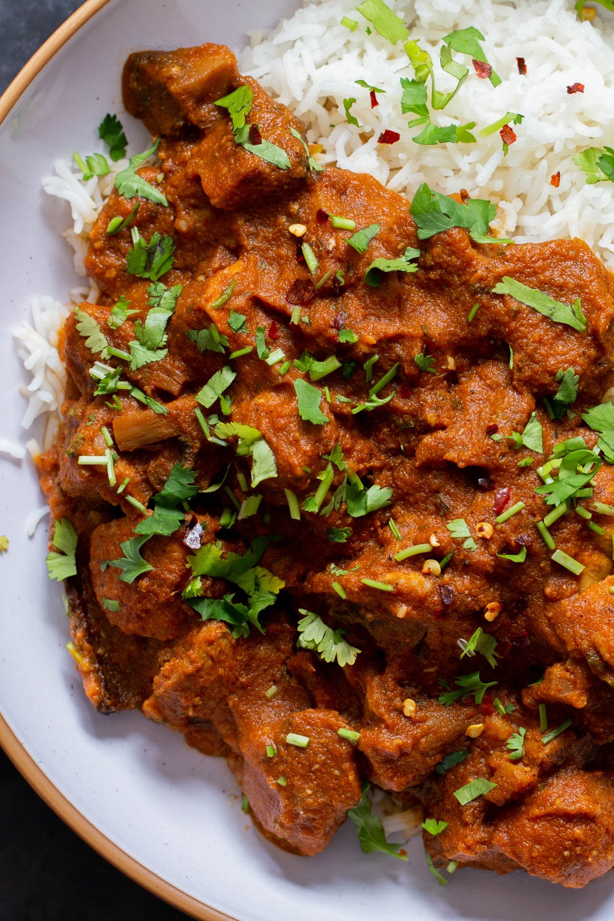 close-up of a bowl of Kashmiri mushrooms, garnished with cilantro