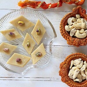 Vegan kaju katli served on a glass plate