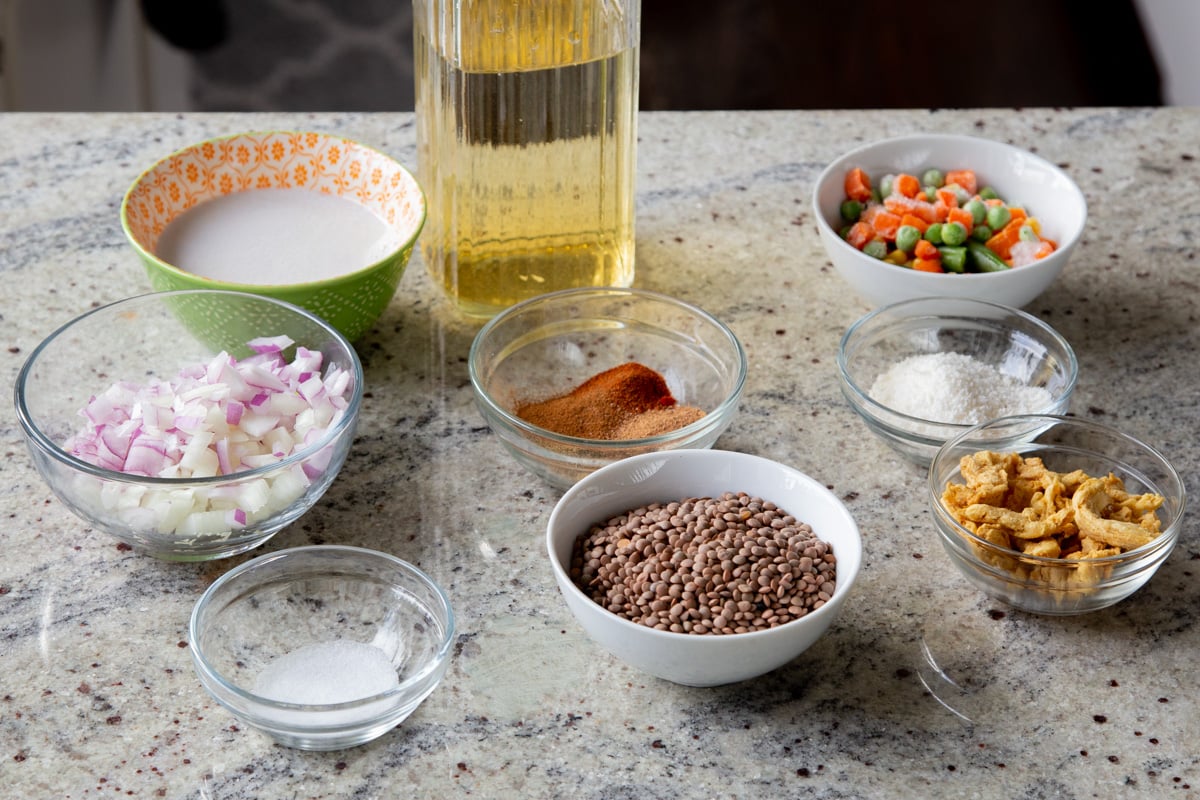 lentils, soy curls, and other curry ingredients in bowls on the kitchen counter