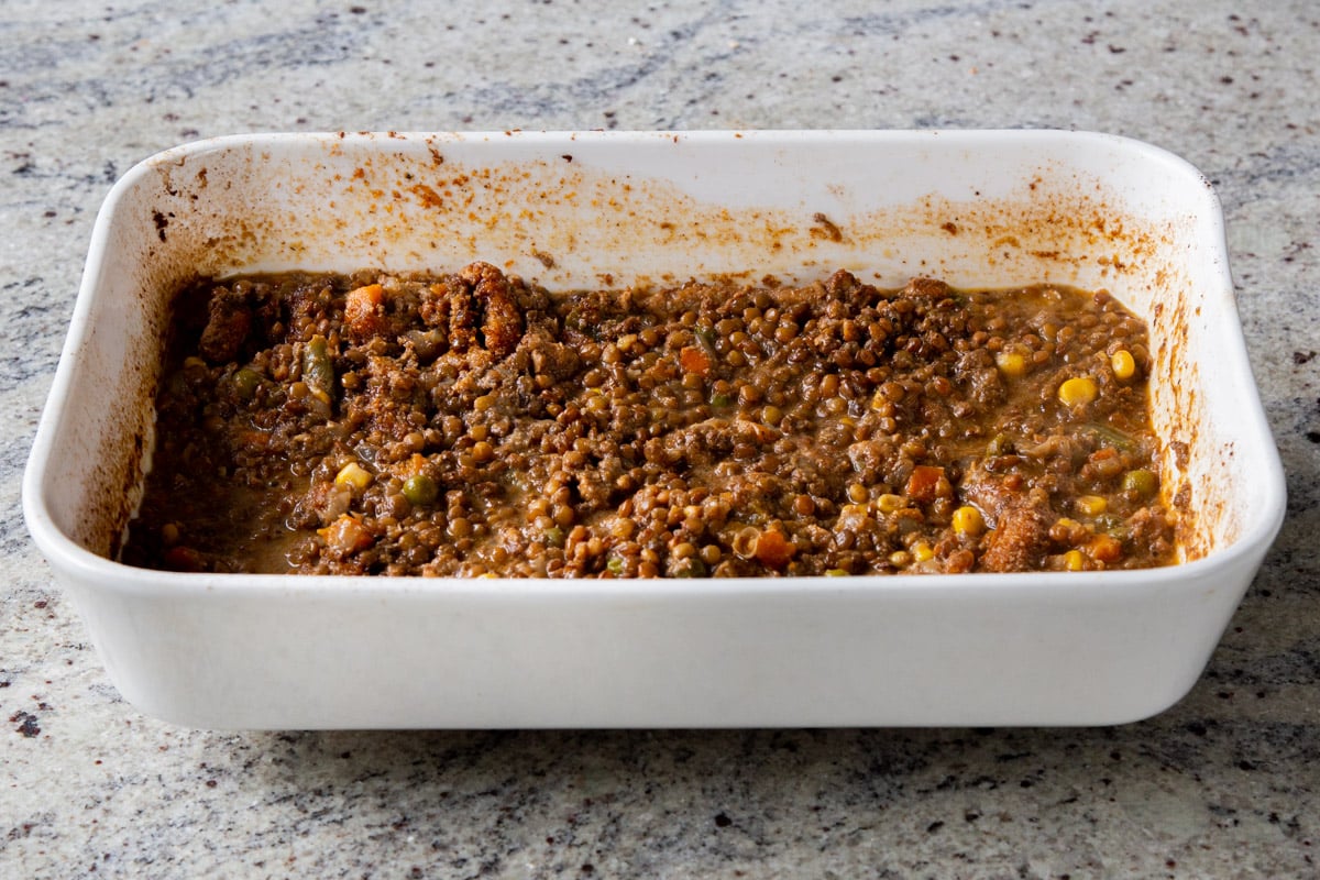 curry mixture after stirring in the water, veggies, lentils, soy curls, and coconut milk, after baking and stirring