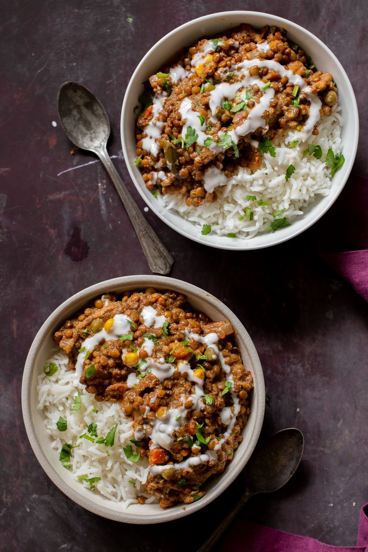 bowls of baked Konkani curry topped with coconut cream, cilantro, and pepper flakes