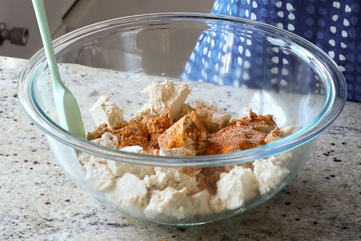 adding spices to the tofu