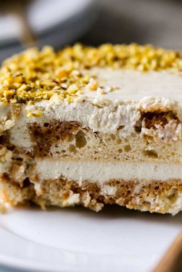 close-up of a slice of Indian tiramisu on a white plate with a fork