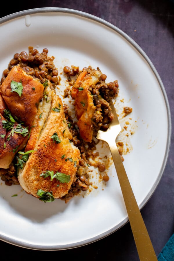 Lentil Keema Pav Casserole on the plate with a bite taken out