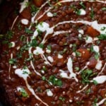 close-up of lentils vindaloo in the pan after adding the toppings