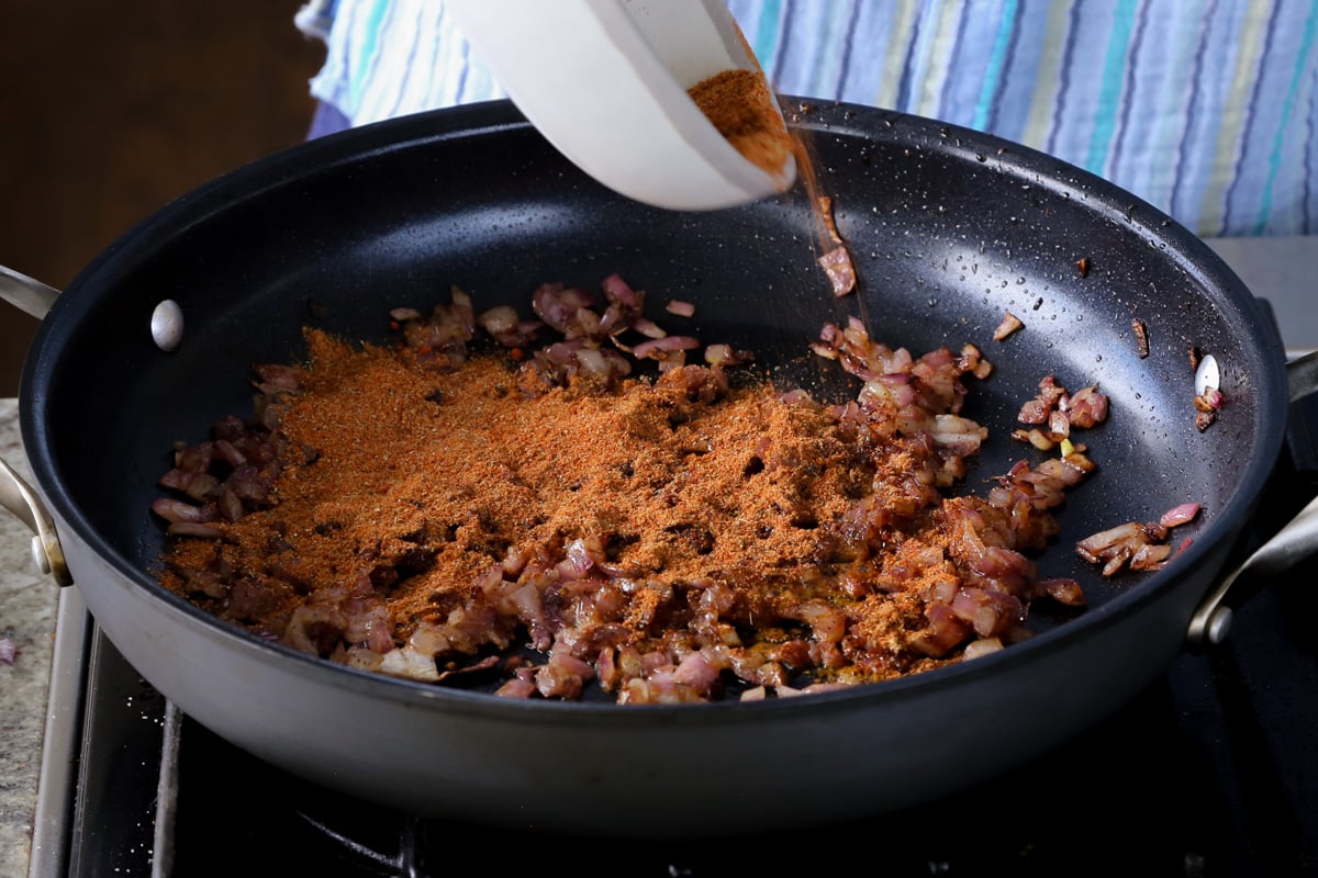 adding vindaloo spice mix to the cooked onions