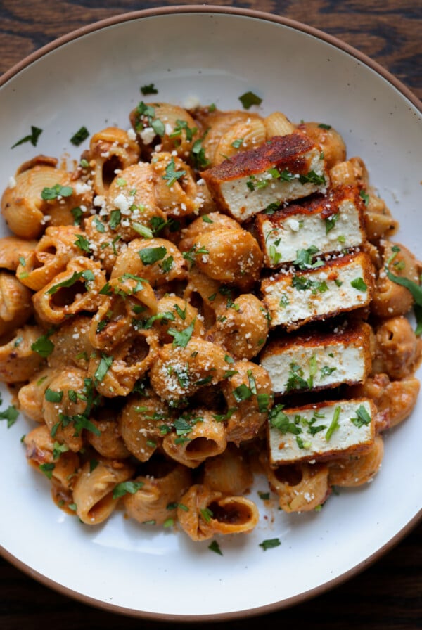 marry me pasta on a white plate with seared tofu pieces