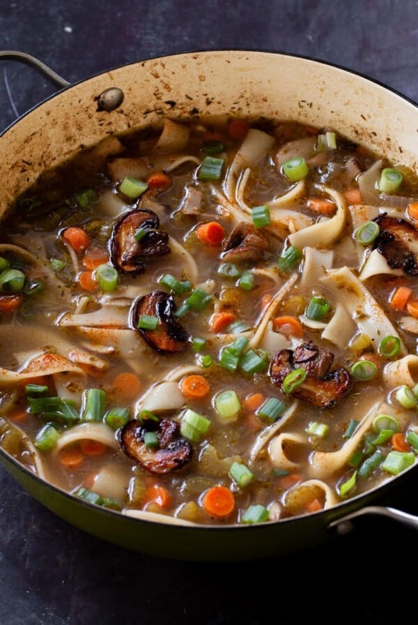 angled shot of mushroom noodle soup in the pan