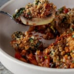 close-up of a fork taking a bite of mushroom parmigiana