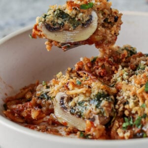 fork taking a bite of mushroom parmesan