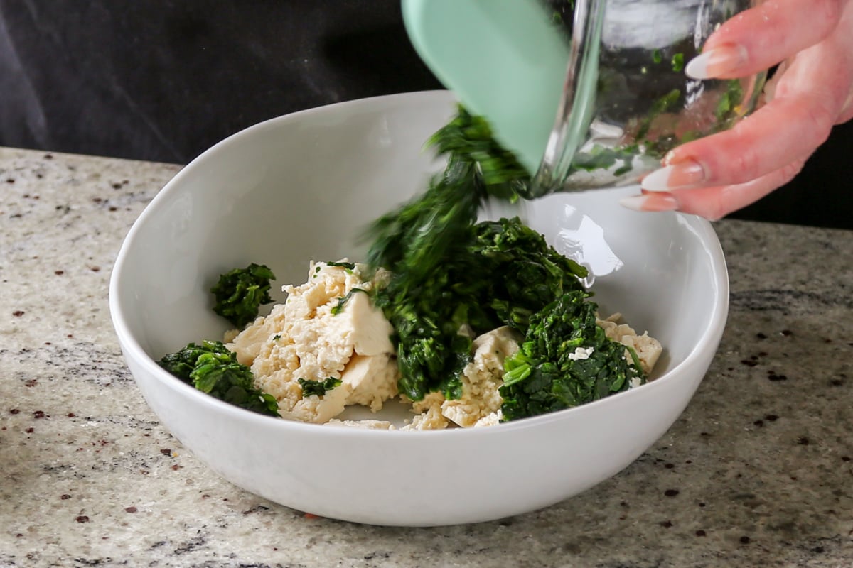 adding the spinach to the tofu