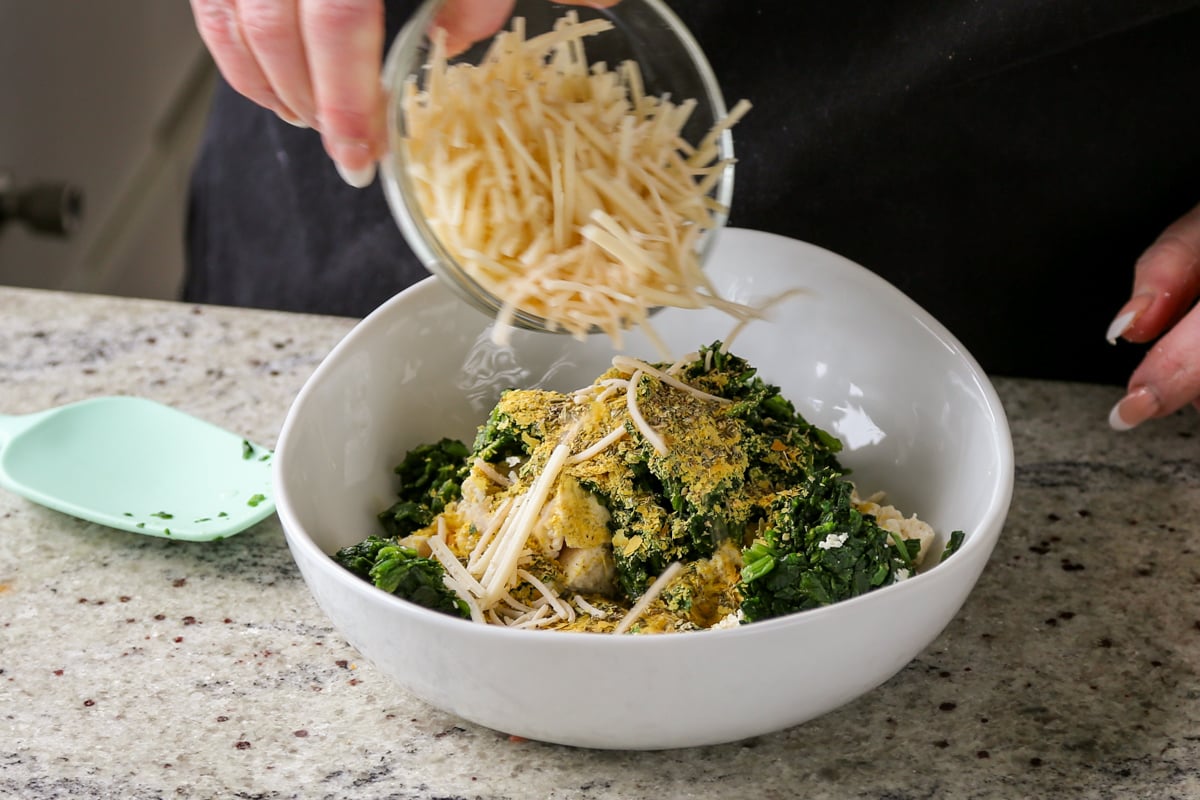 adding vegan cheeses to the tofu-spinach mixture