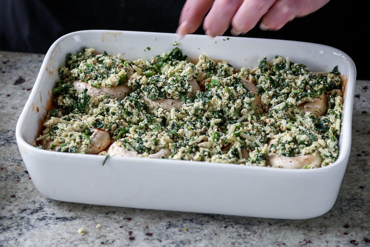 topping the mushrooms with the spinach-cheese mixture