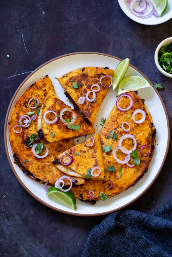 mushroom quesatacos cut up on a plate, so you can see the filling better