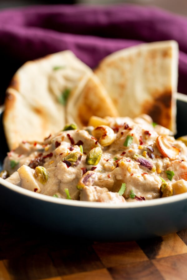 a bowl of baked Navratan Korma with Pita Bread