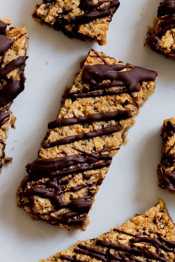 close-up of crunchy granola bars with chocolate topping on a white plate