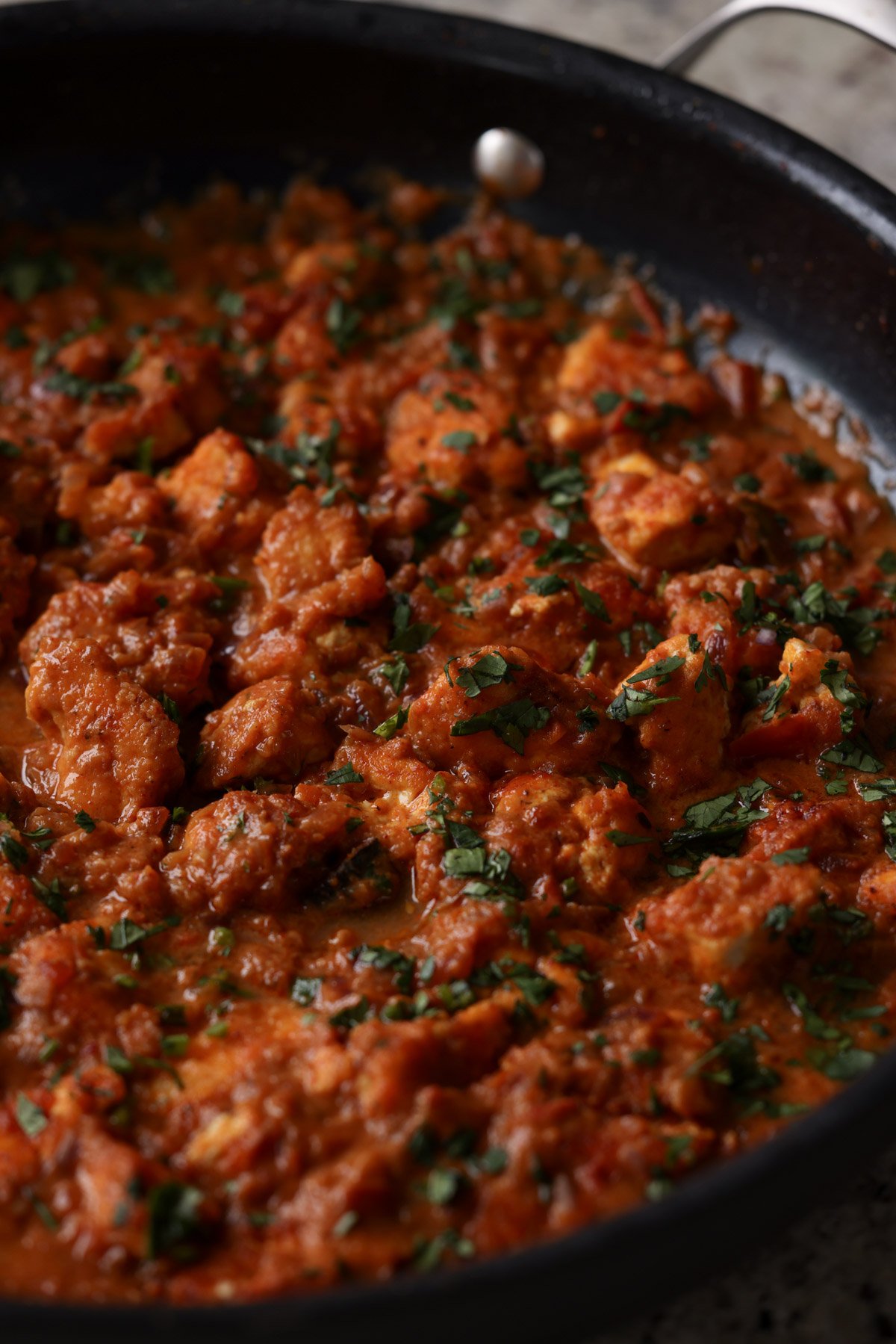 close-up of salli boti in a pan after cooking