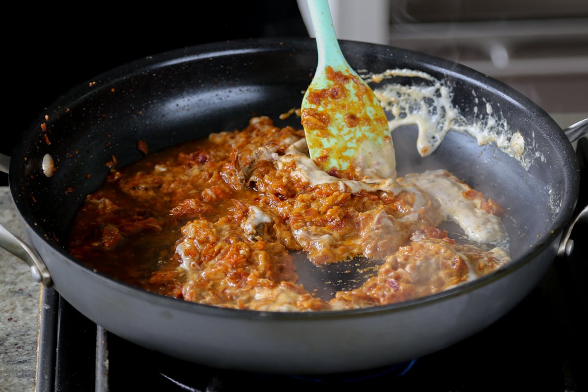 stirring the boti curry sauce ingredients together in the pan