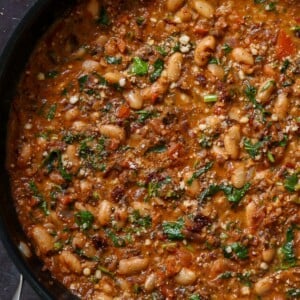 vegan sausage pasta sauce in the pan, with garnish