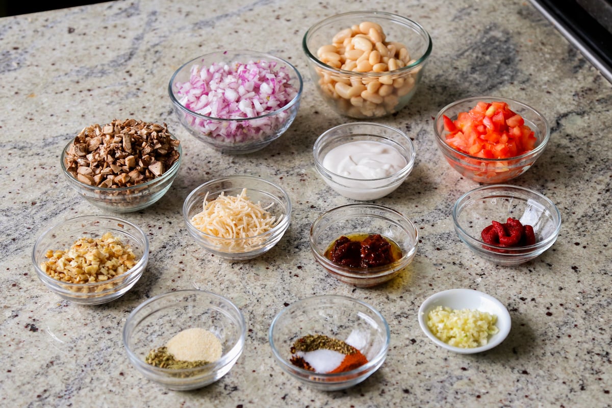 vegan sausage pasta sauce ingredients in bowls on the kitchen counter