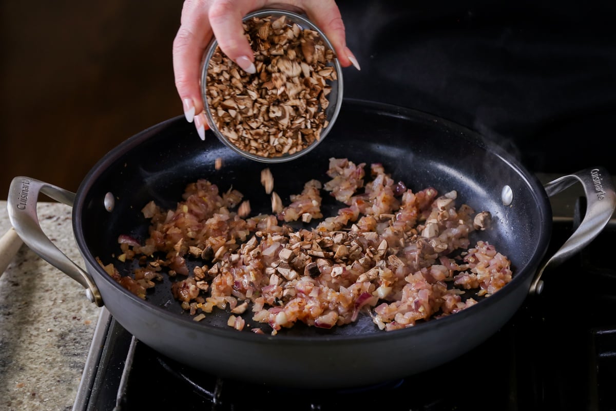 adding mushrooms to the pan