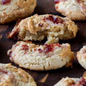 close-up of a gluten free peanut butter and jelly cookie broken in half, so you can see the texture inside