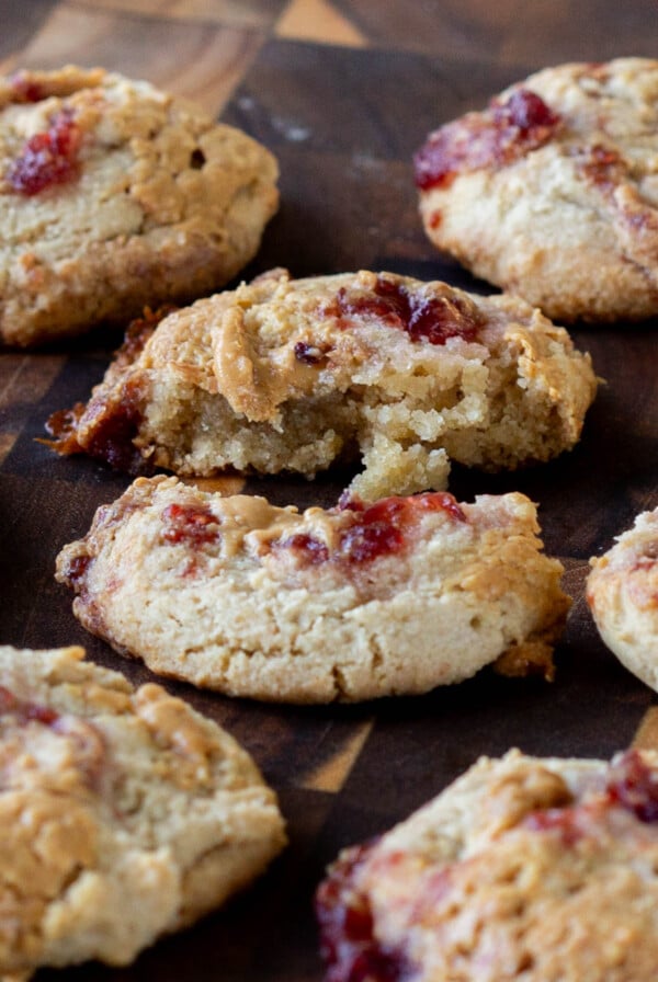 close-up of a gluten free peanut butter and jelly cookie broken in half, so you can see the texture inside