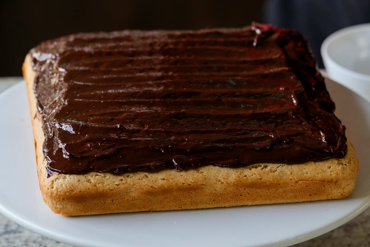 peanut butter cake after spreading on chocolate glaze