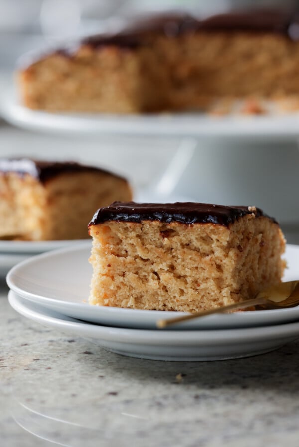 slice of peanut butter cake with chocolate peanut butter glaze