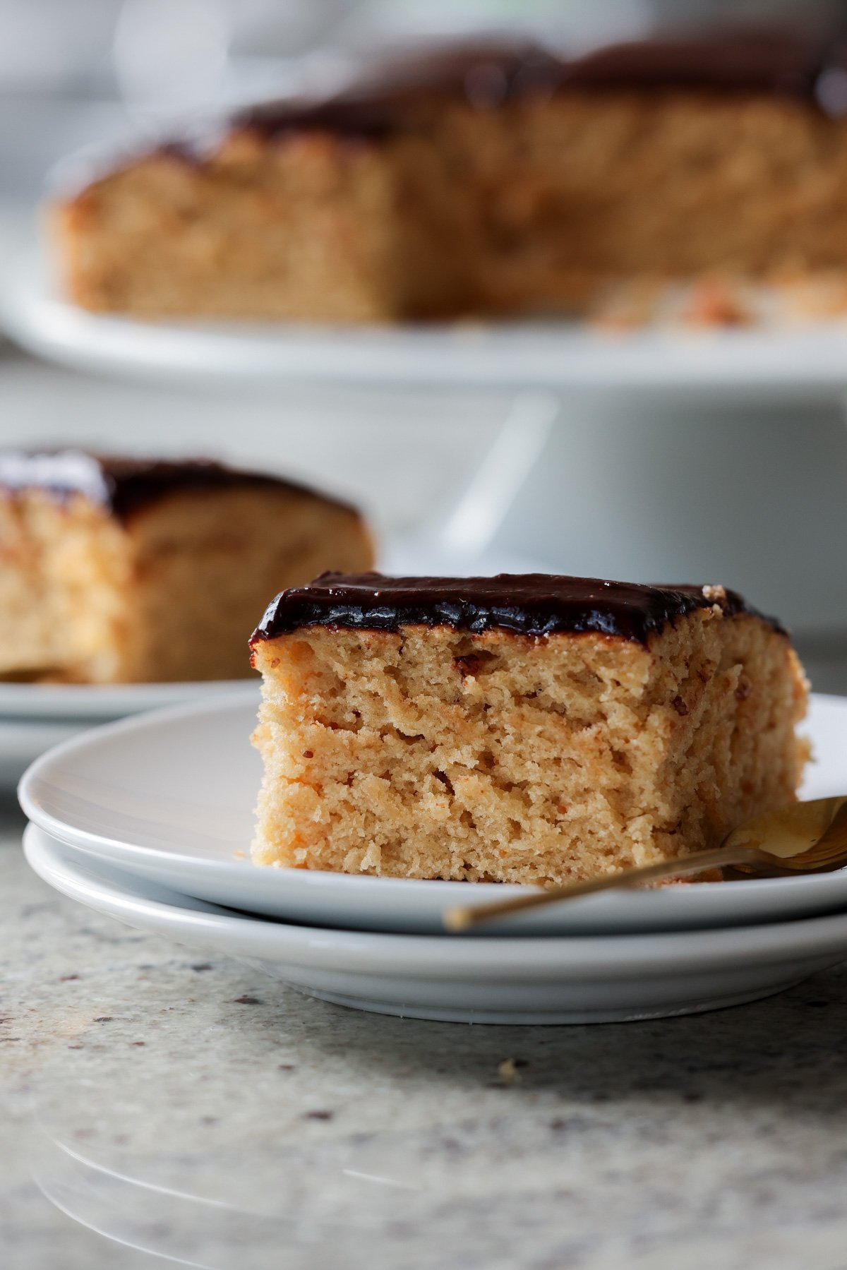 slice of peanut butter cake with chocolate peanut butter glaze