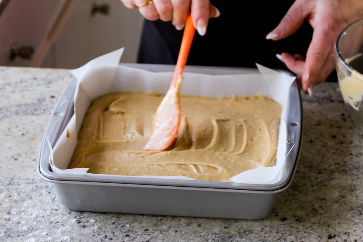 evening out the top of the peanut butter cake batter in the pan