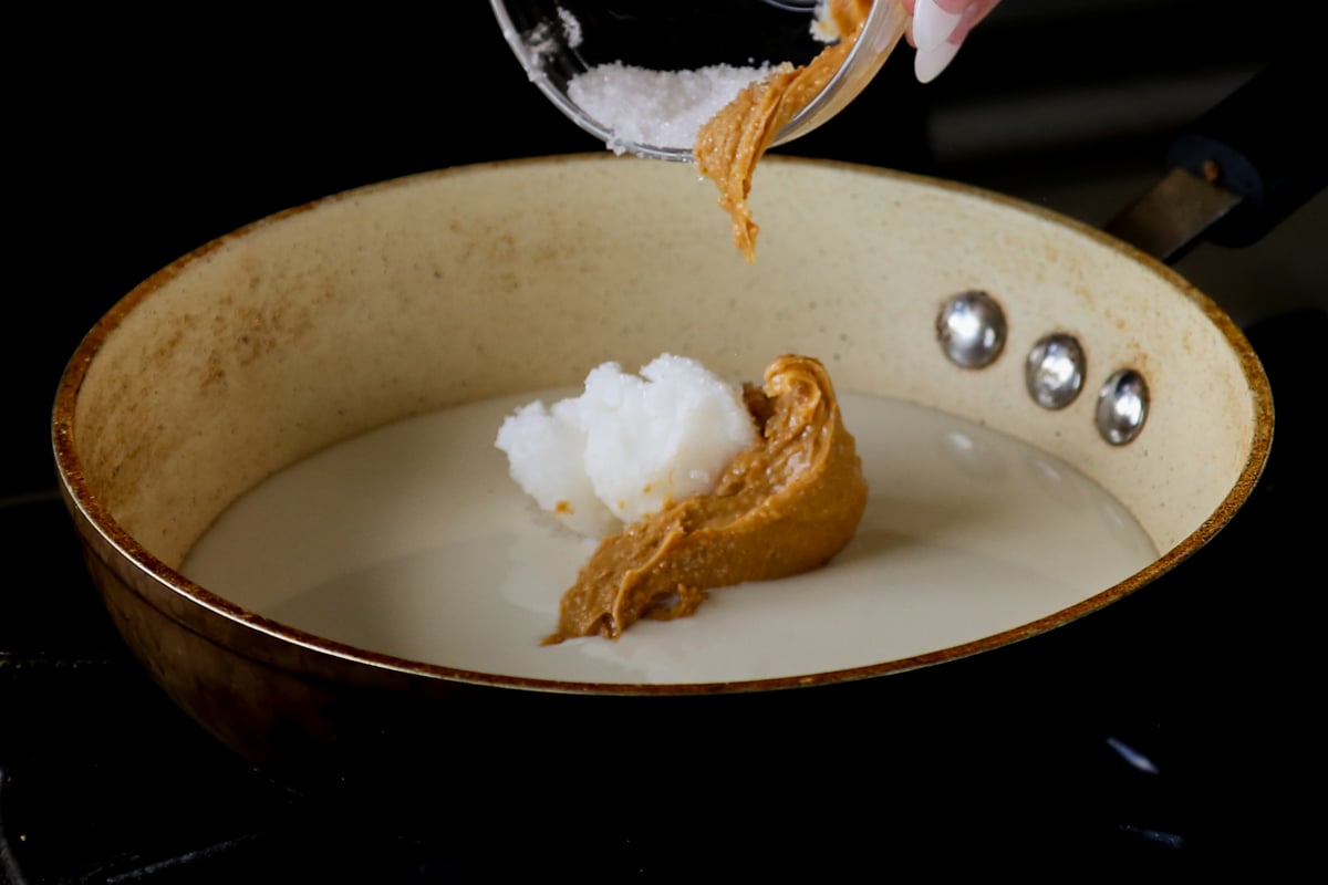 adding peanut butter, non-dairy milk, and coconut oil to the pan