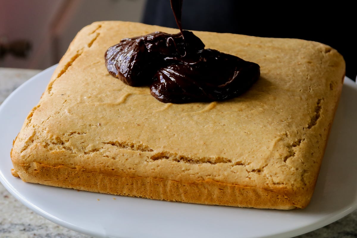 chocolate peanut butter glaze on top of the cake before spreading it out