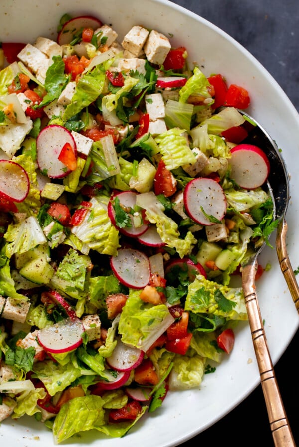 close-up of chaat masala salad in the mixing bowl with serving spoons