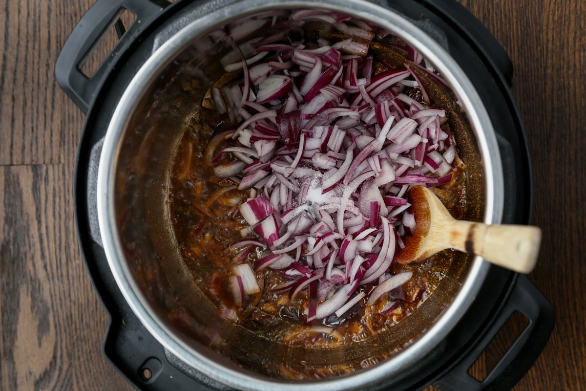 adding onions to the pot