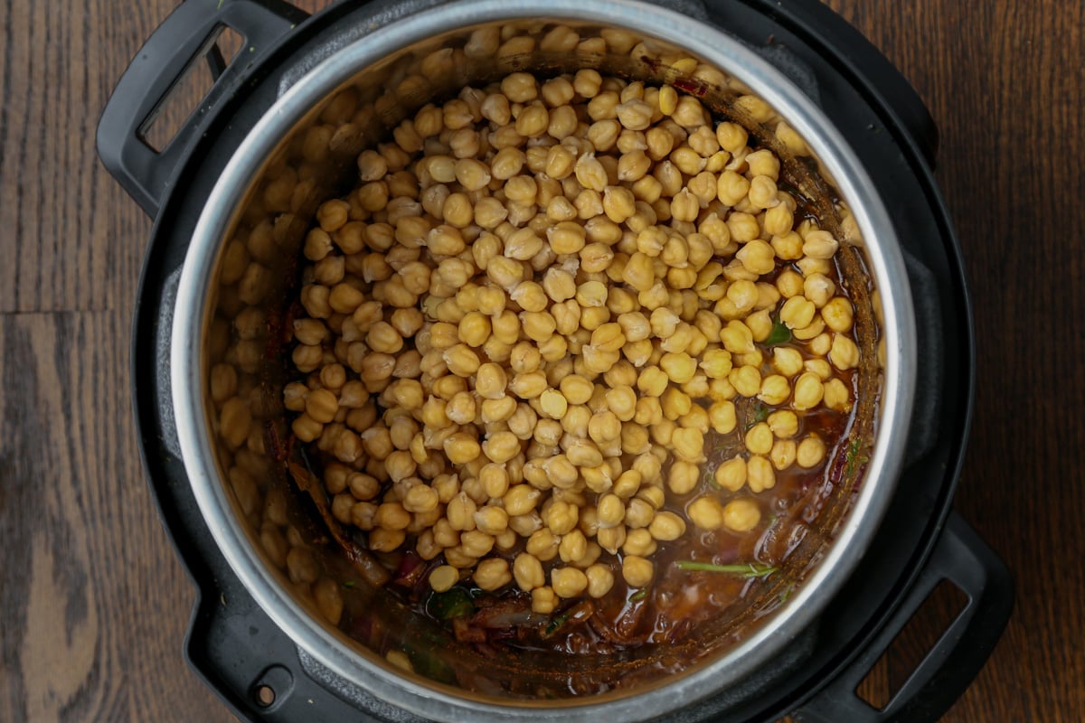 adding chickpeas to the pot