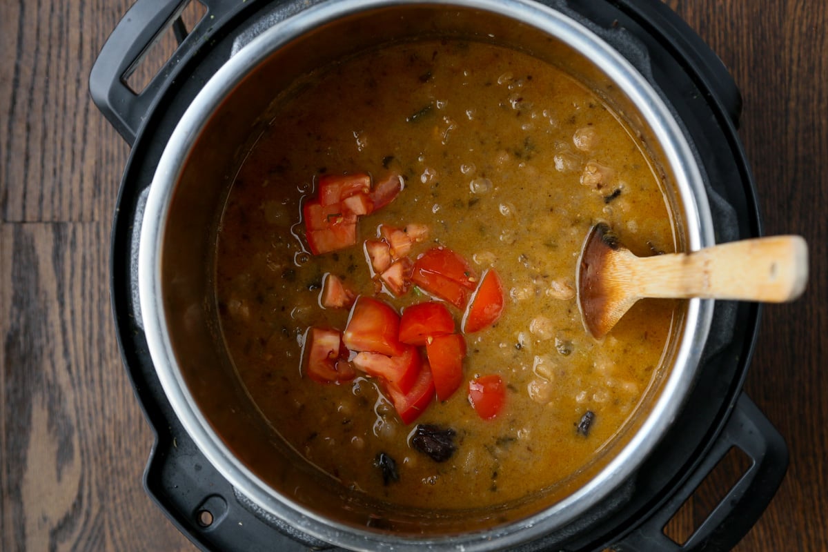 adding tomato to the Punjabi chole