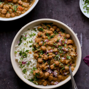 bowls of Punjabi chole on a slate table