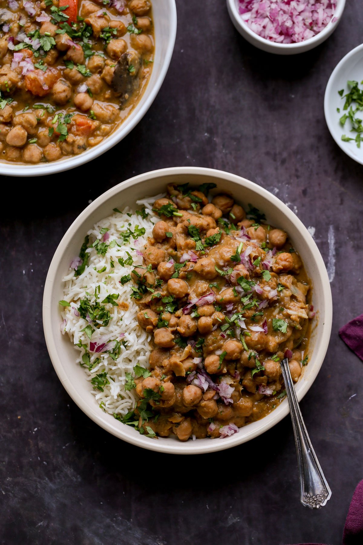 bowls of Punjabi chole on a slate table