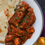 rara chicken curry on a plate with flatbread