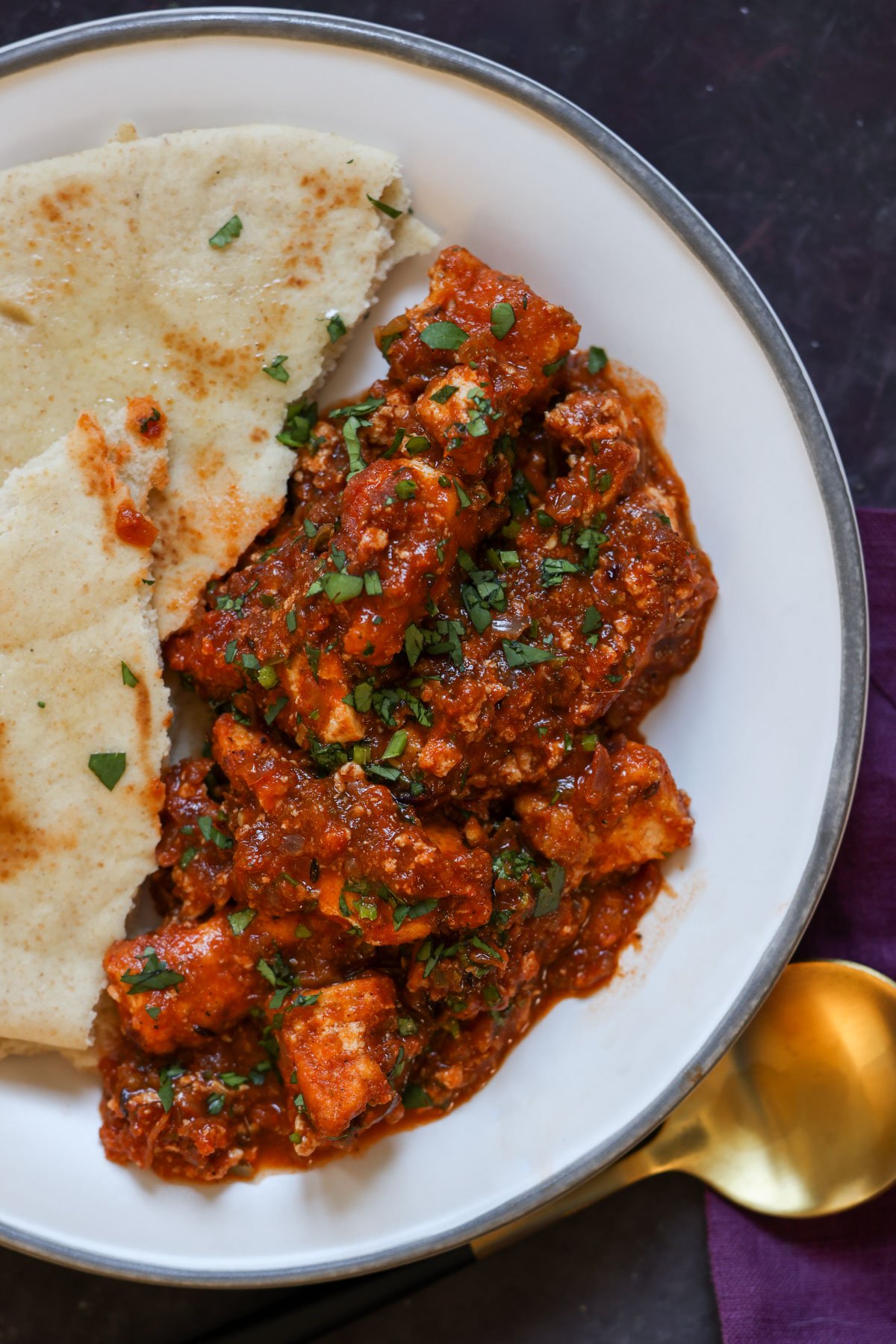 rara chicken curry on a plate with flatbread