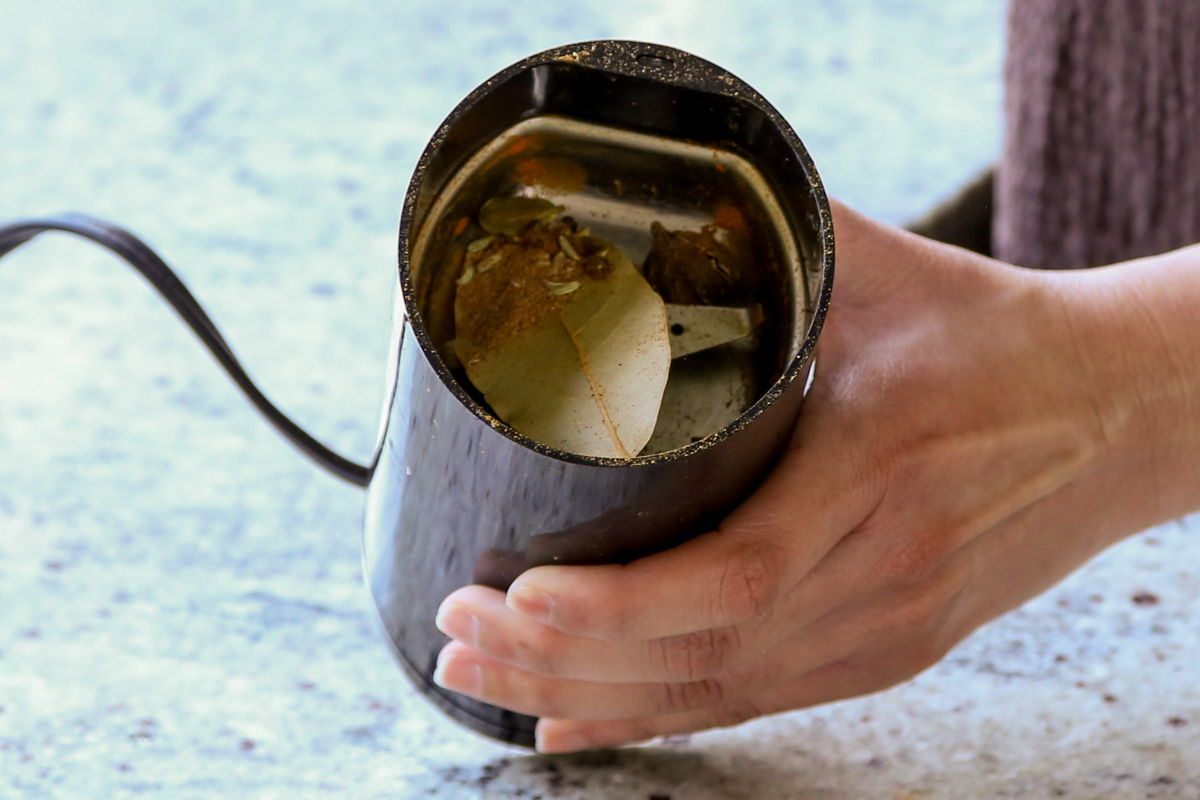 whole spices in the spice grinder before grinding